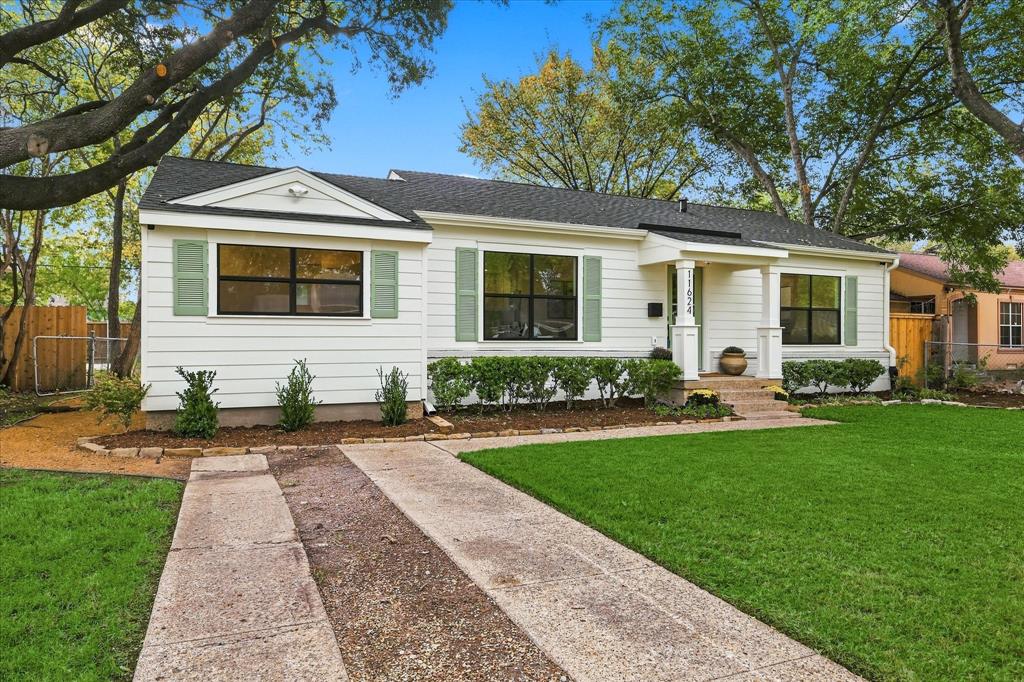 Traditional exterior featuring horizontal siding, green shutters, a covered front entryway with structural columns, and a double-lane paved driveway Traditional exterior featuring horizontal siding, green shutters, a covered front entryway with structural columns, and a double-lane paved driveway