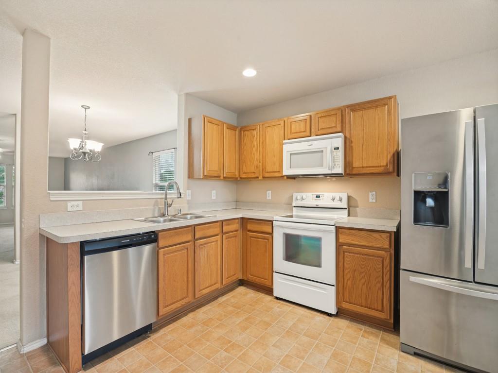 Large eat-in kitchen with abundant cabinetry, counter space and recessed lighting.