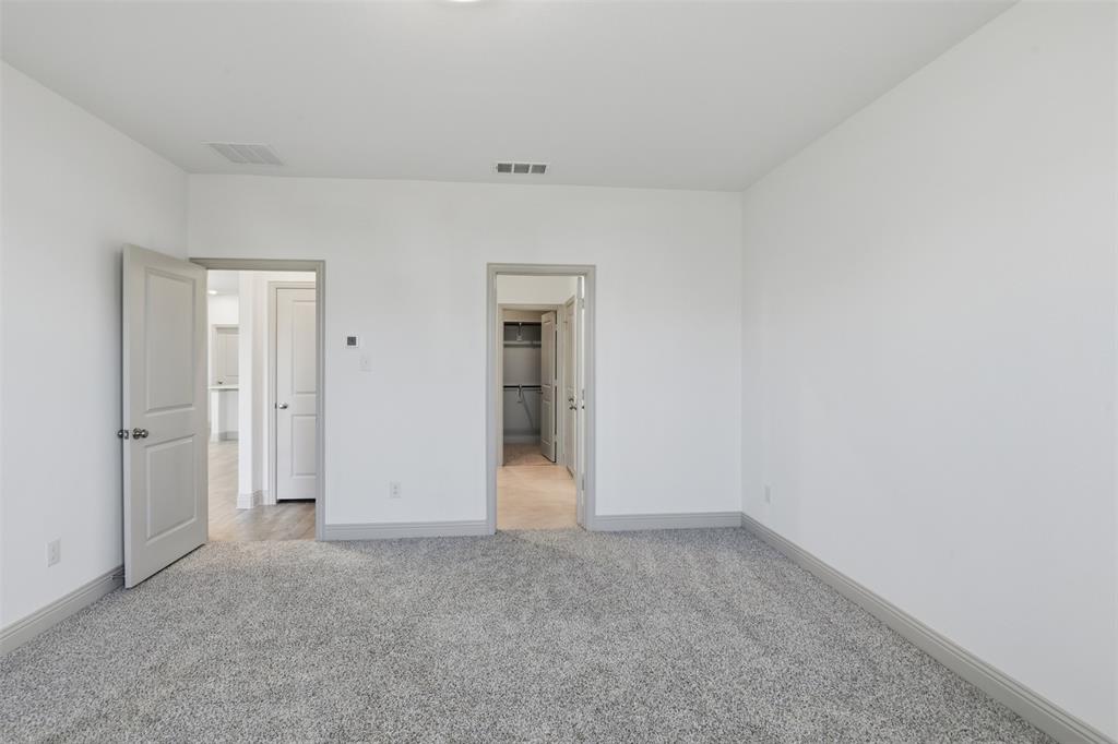 Neutral wall paint, high-pile carpeting, and solid-core interior doors with coordinating trim