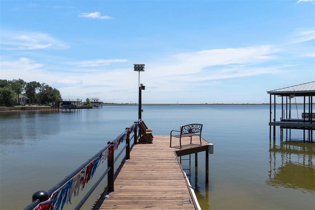Extended Fishing Pier Overlooking The Lake