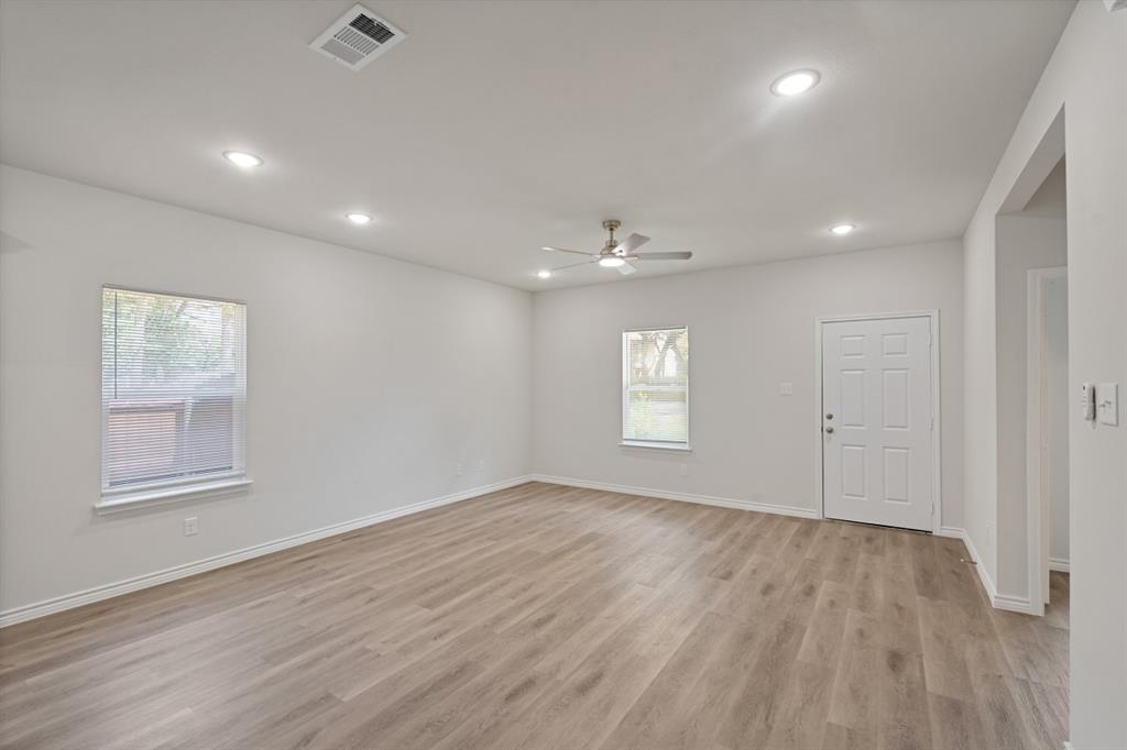Interior space featuring wood-finish flooring, recessed lighting, a ceiling fan, and white walls