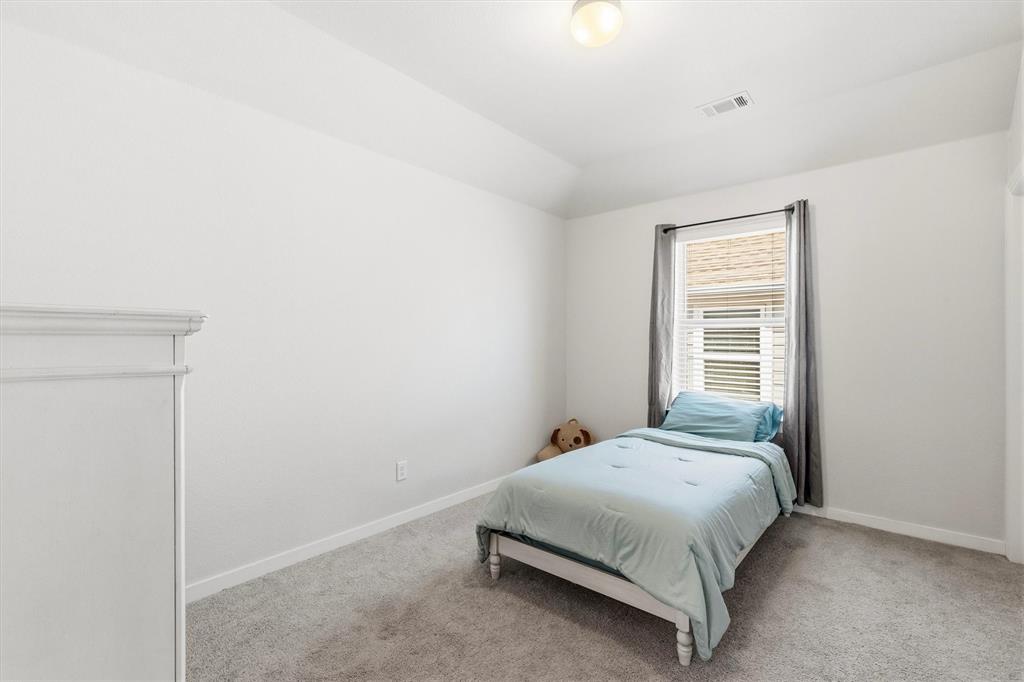 Room featuring neutral wall tones, high vaulted ceilings, wall-to-wall carpeting, and a window with horizontal blinds