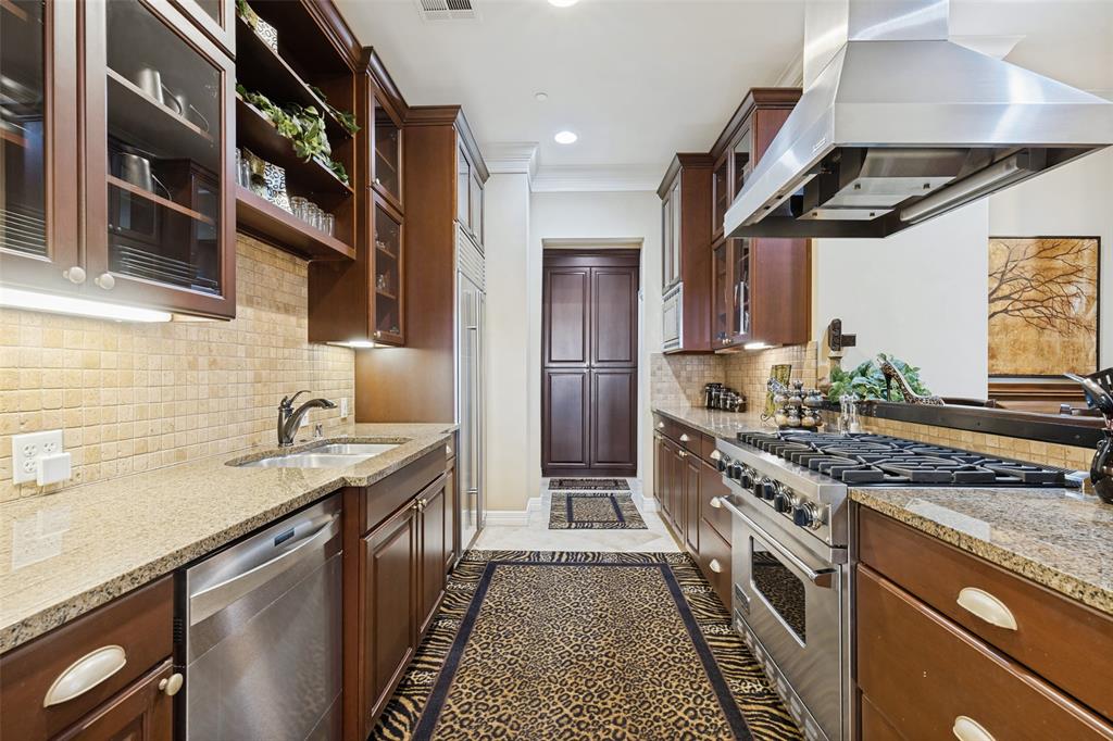 Stunning kitchen with beautiful built in cabinetry, granite countertops & a subzero refrigerator