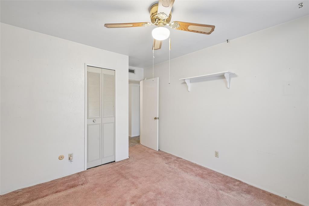 Ceiling fan and a louvered-door closet.