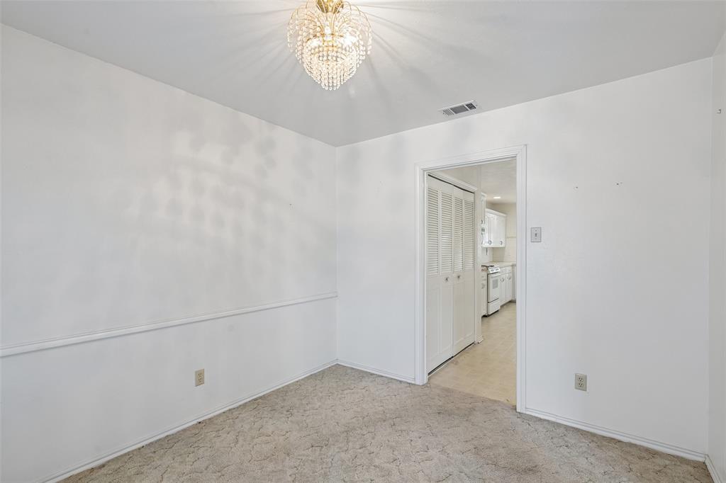 A separate dining room with a chandelier, just off the kitchen.