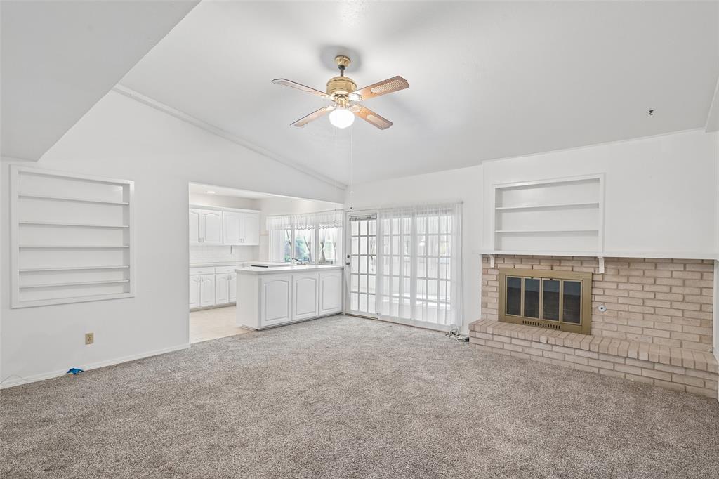 Vaulted ceiling, built-in shelves and a brick wood-burning fireplace anchor the living room. Vaulted ceiling, built-in shelves and a brick wood-burning fireplace anchor the living room.