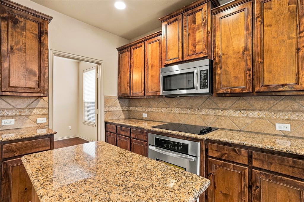 Granite counter tops, island, electric cooktop and oven.