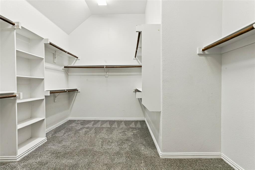 Walk-in closet in primary suite has plenty of space with buitin shelves.