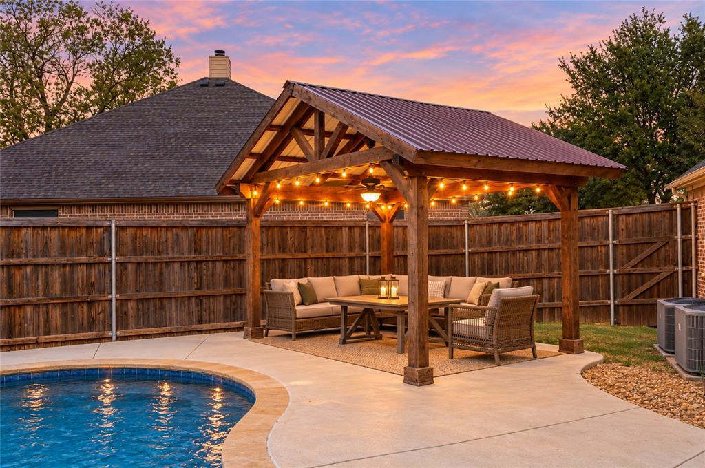 Relax at night under the lighted pergola by the pool! Virtually staged.