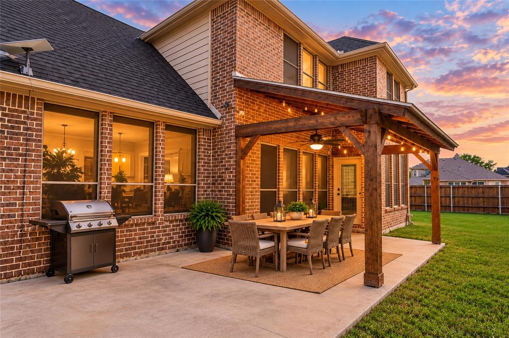 Covered patio has plenty of space for dining and grilling. Virtually staged.