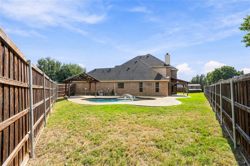 Large yard area surrounds the pool.