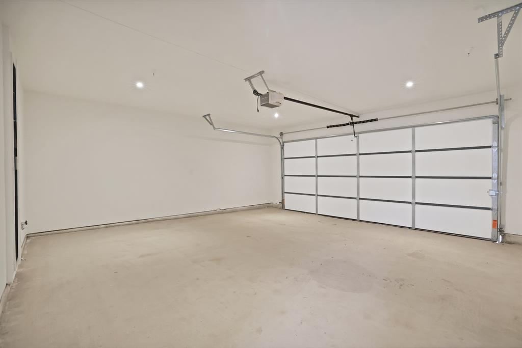 Garage featuring a garage door opener