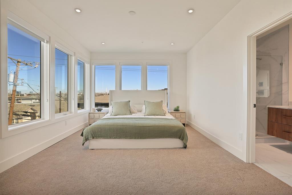 Bedroom with ensuite bath and light carpet