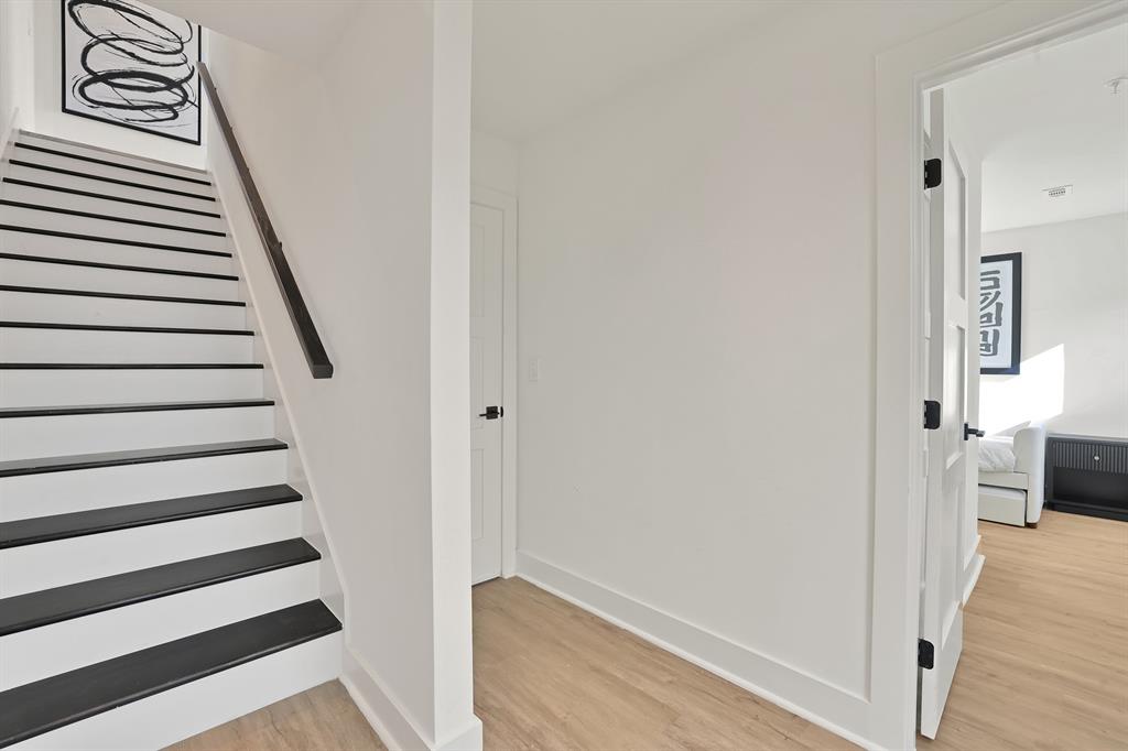 Stairs featuring hardwood / wood-style flooring