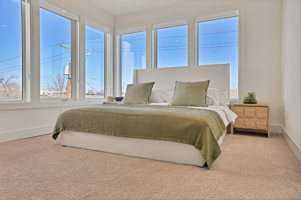 Carpeted bedroom with multiple windows