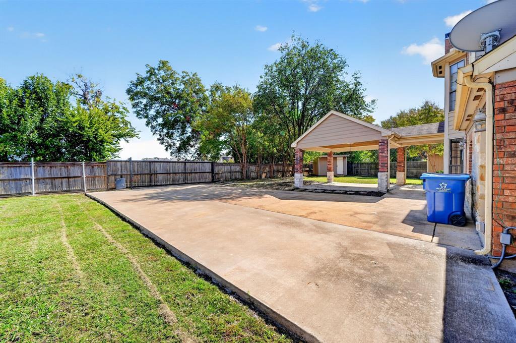 room for boat and or RV Backyard featuring a covered patio, concrete hardscaping, wood privacy fencing, and mature trees