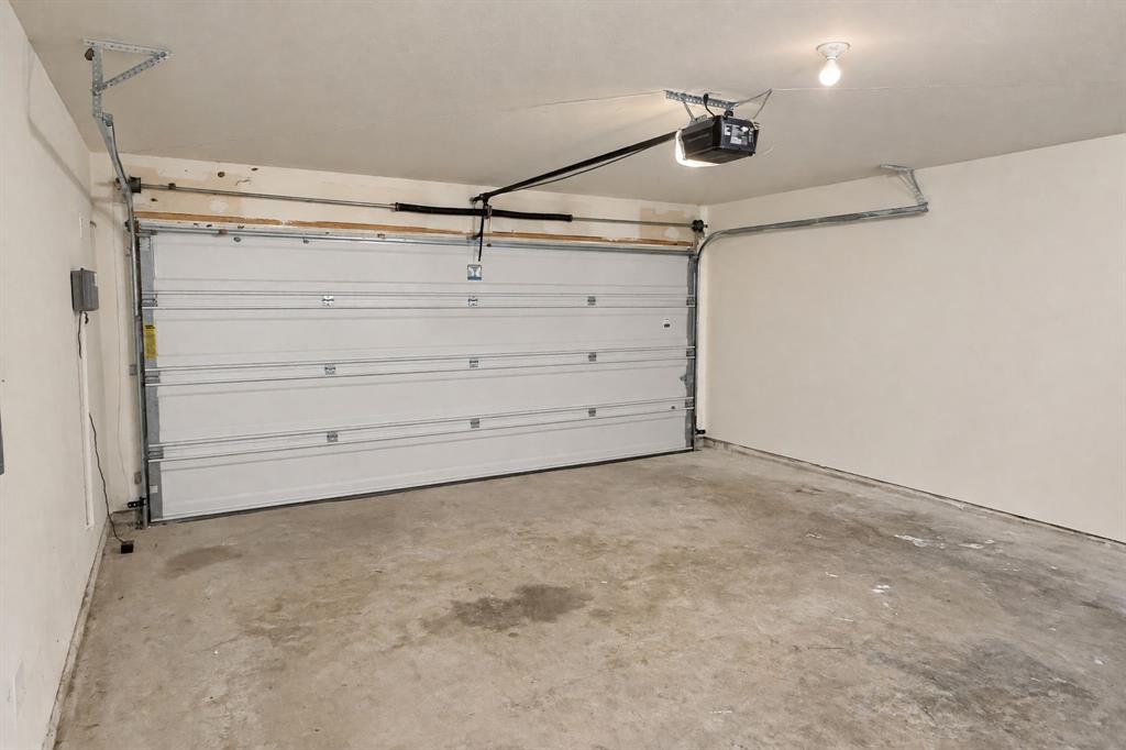 Multi-car garage featuring a sectional metal door and automated opener