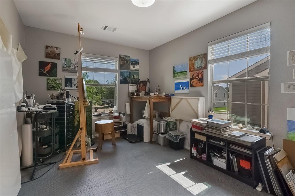 Interior room featuring neutral-toned walls, dual pane windows with grid detailing, and low-maintenance textured flooring