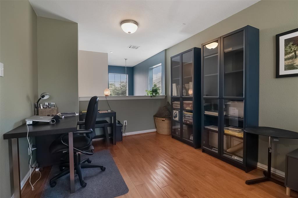 Wood-finish flooring, half-wall partition, and ceiling-mounted dome lighting