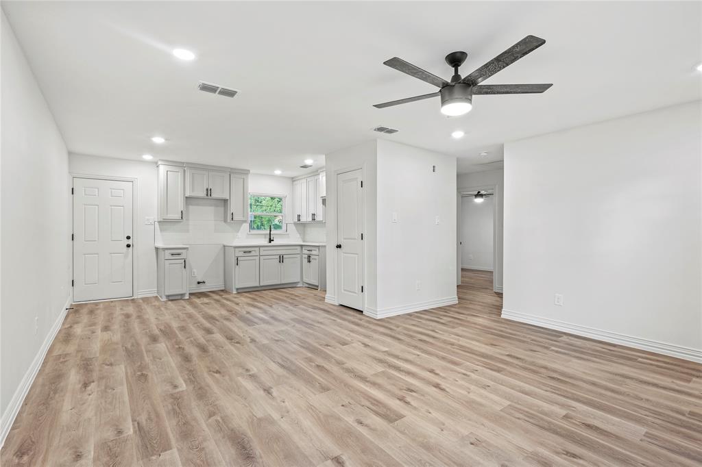 Unfurnished living room with ceiling fan, light wood-style floors, baseboards, and recessed lighting Unfurnished living room with ceiling fan, light wood-style floors, baseboards, and recessed lighting