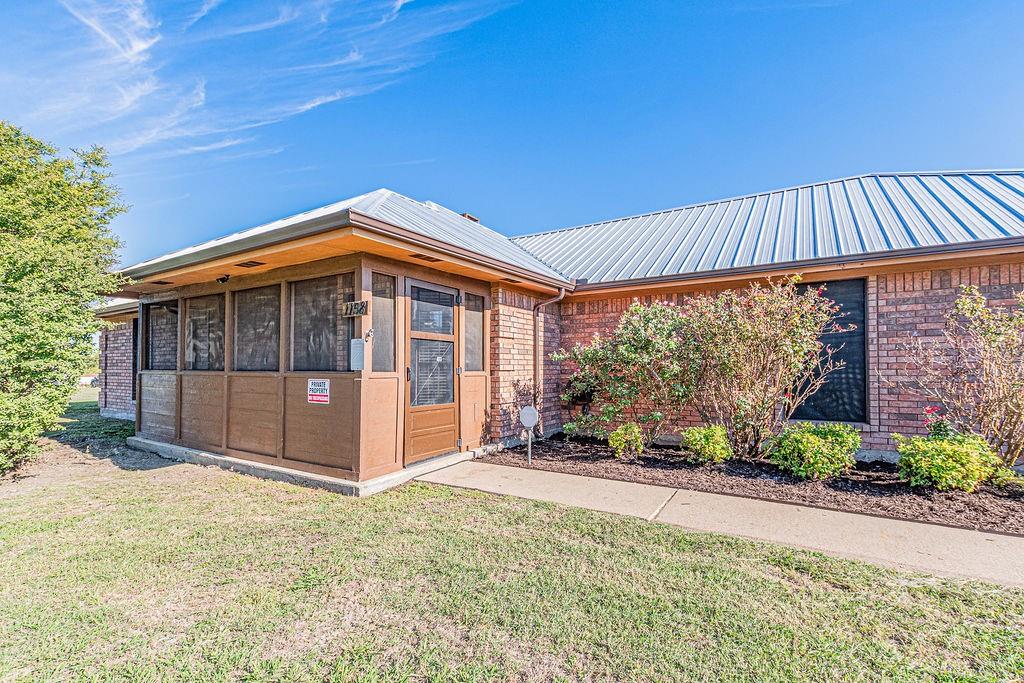 A screened in porch greets your visitors