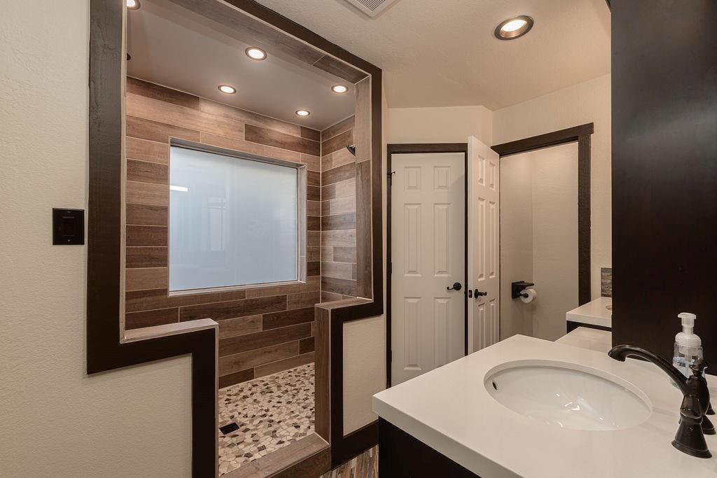 The ensuite primary bathroom features a large walk-in shower