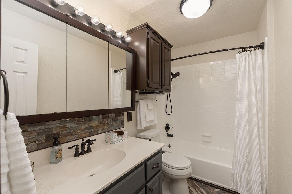 Full bathroom with a tub-shower combo