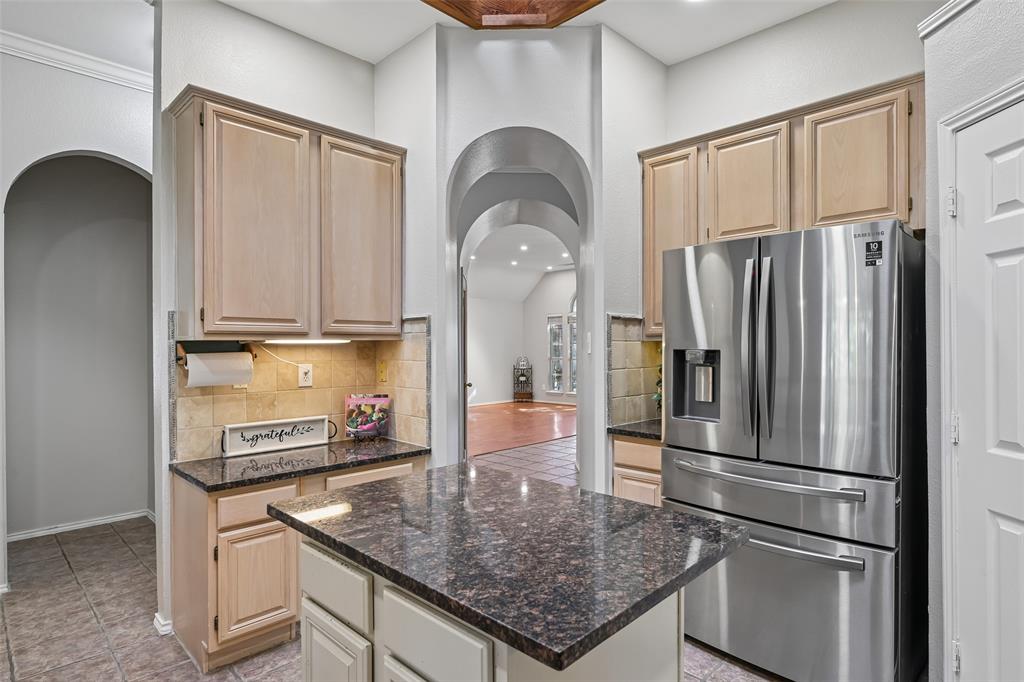 Kitchen featuring light wood cabinetry, granite counters, coffee bar and built in work area