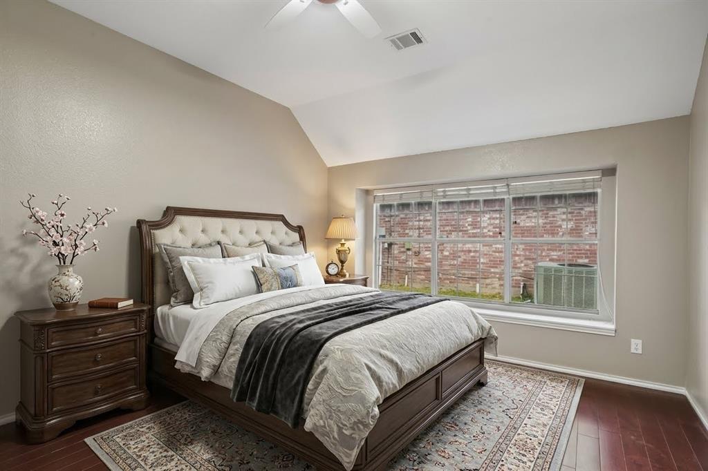 Vaulted ceilings, expansive multi-pane window, and wood-finish flooring
