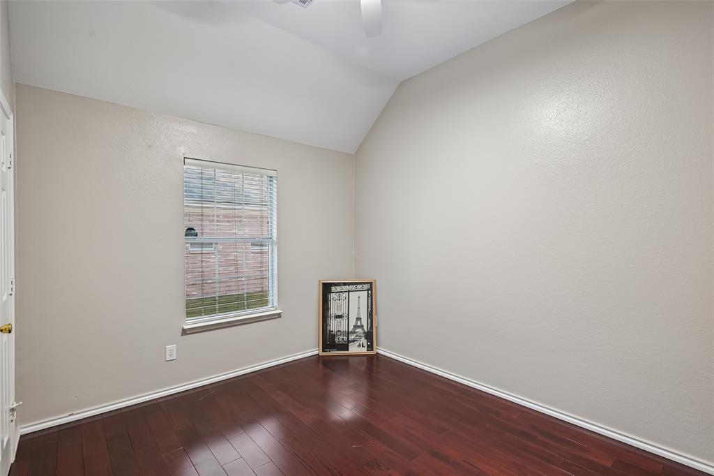 Vaulted ceiling, wood-finish flooring, and a single-hung window