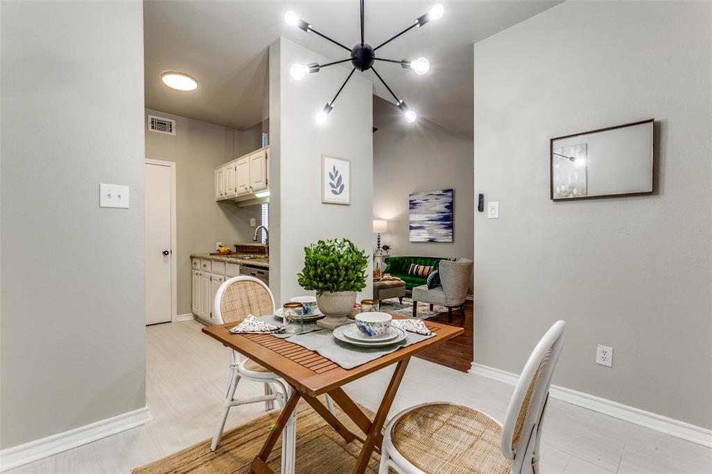 Multi-arm sputnik chandelier, white cabinetry, and light-toned flooring