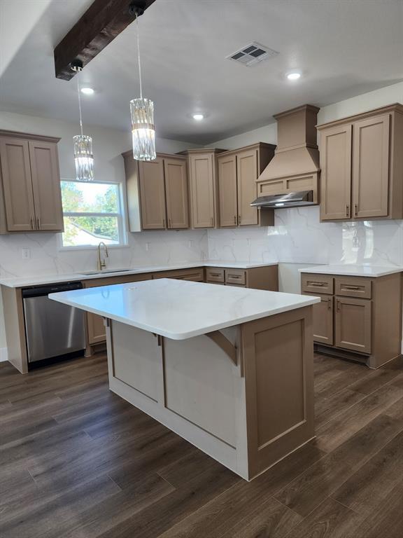 Kitchen featuring cabinetry with a matte finish, white countertops with veining, a stainless steel range hood, wood-finish flooring, and a decorative exposed ceiling beam Kitchen featuring cabinetry with a matte finish, white countertops with veining, a stainless steel range hood, wood-finish flooring, and a decorative exposed ceiling beam