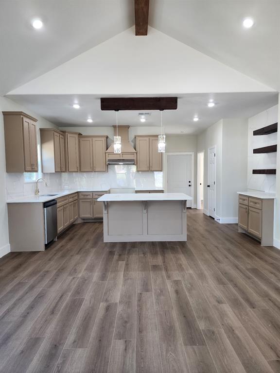 Kitchen featuring a vaulted ceiling with exposed beam, wood-finish flooring, central island with quartz countertop, shaker-style cabinetry, and recessed lighting Kitchen featuring a vaulted ceiling with exposed beam, wood-finish flooring, central island with quartz countertop, shaker-style cabinetry, and recessed lighting