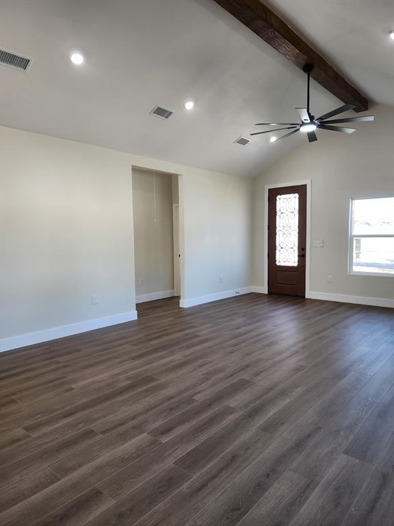 Vaulted ceiling featuring an exposed wood beam, wood-finish flooring, recessed lighting, ceiling fan with integrated light, and an entry door with decorative glass inlay Vaulted ceiling featuring an exposed wood beam, wood-finish flooring, recessed lighting, ceiling fan with integrated light, and an entry door with decorative glass inlay