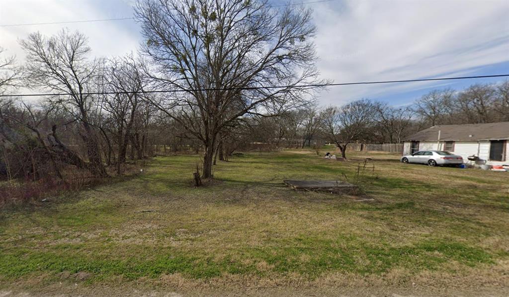 Expansive lot featuring mature trees and established grass