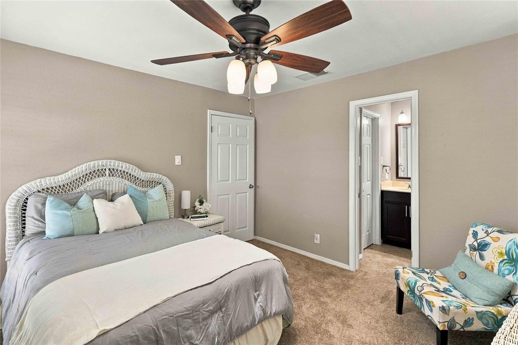 Room featuring wall-to-wall carpeting, a dark-finish ceiling fan with integrated lighting, and a six-panel door