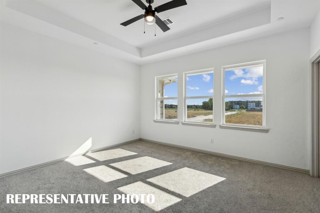 This peaceful and relaxing owner's bedroom is the perfect place for you to relax and unwind at the end of the day.  REPRESENTATIVE PHOTO