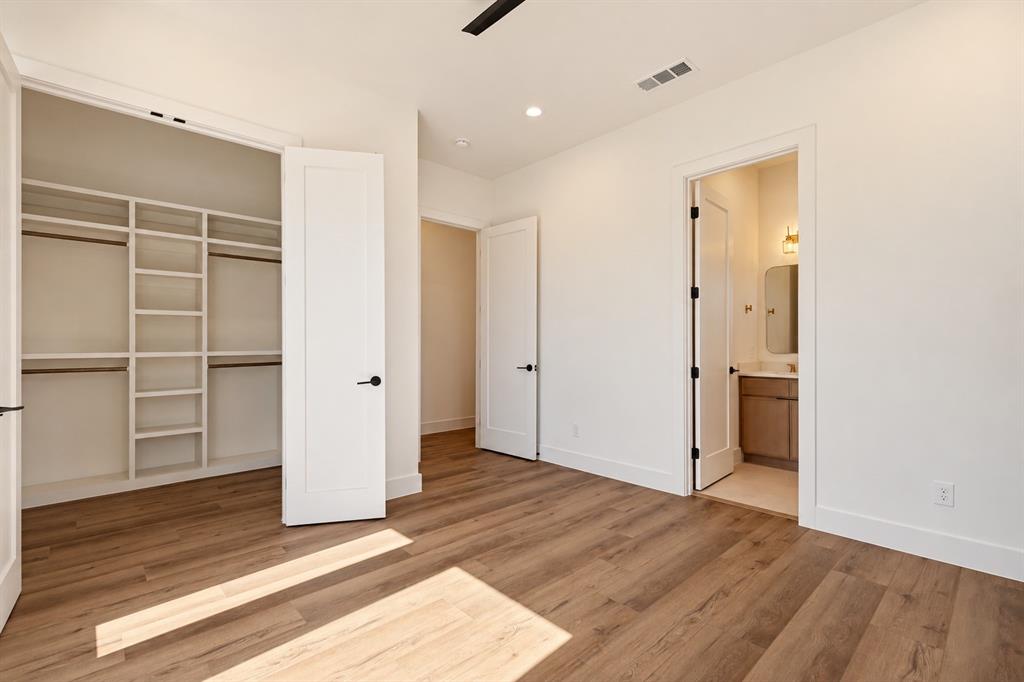 Wood-finish flooring, recessed lighting, and a built-in closet system