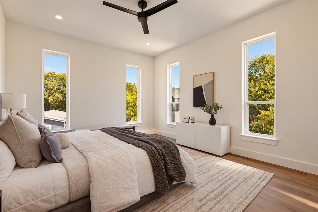 Wood-finish flooring, recessed lighting, and a contemporary ceiling fan