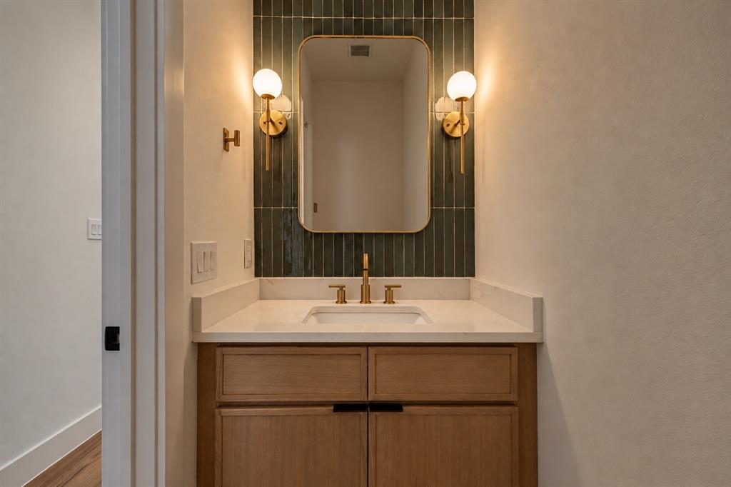 Wood-finish vanity with an integrated sink and light-toned countertop