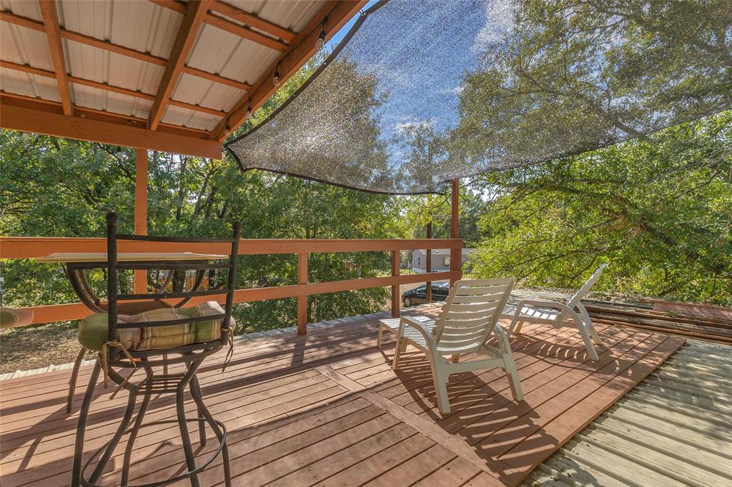 Upper deck with covered seating area and tree views