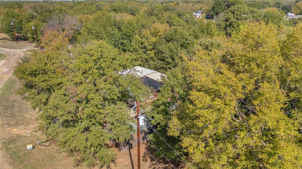 Aerial view of the wooded setting around the home