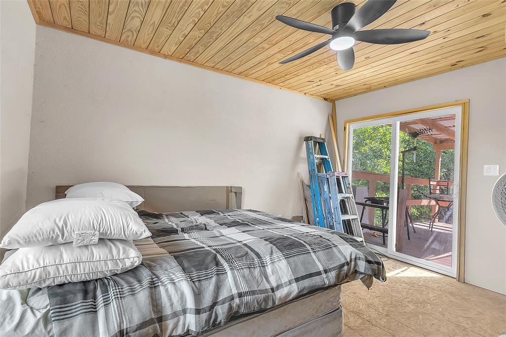 Bedroom with sliding glass door to covered deck and ceiling fan