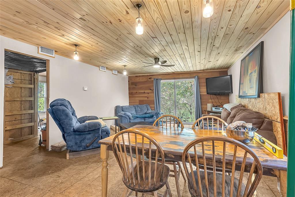 Dining and living space with wood accent wall and sliding glass door