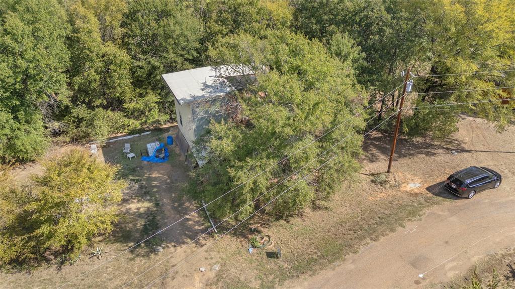 Aerial view of home and tree-covered lot along Baff Bay Dr