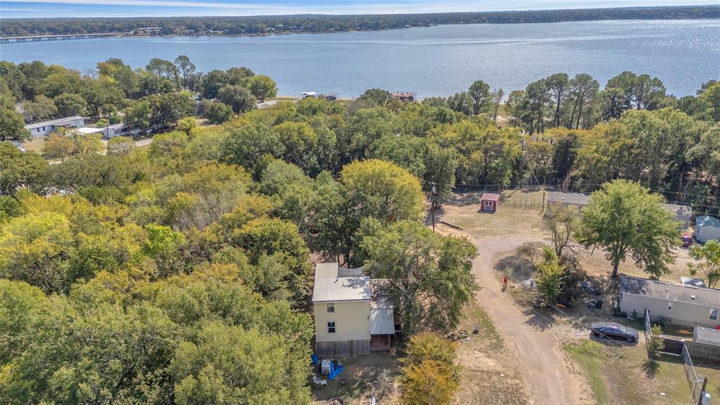 Aerial view showing the home with Cedar Creek Lake just beyond