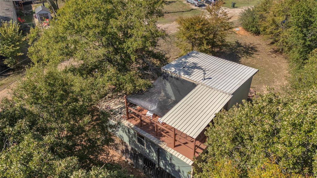 Overhead view of metal roof and covered upper deck among trees