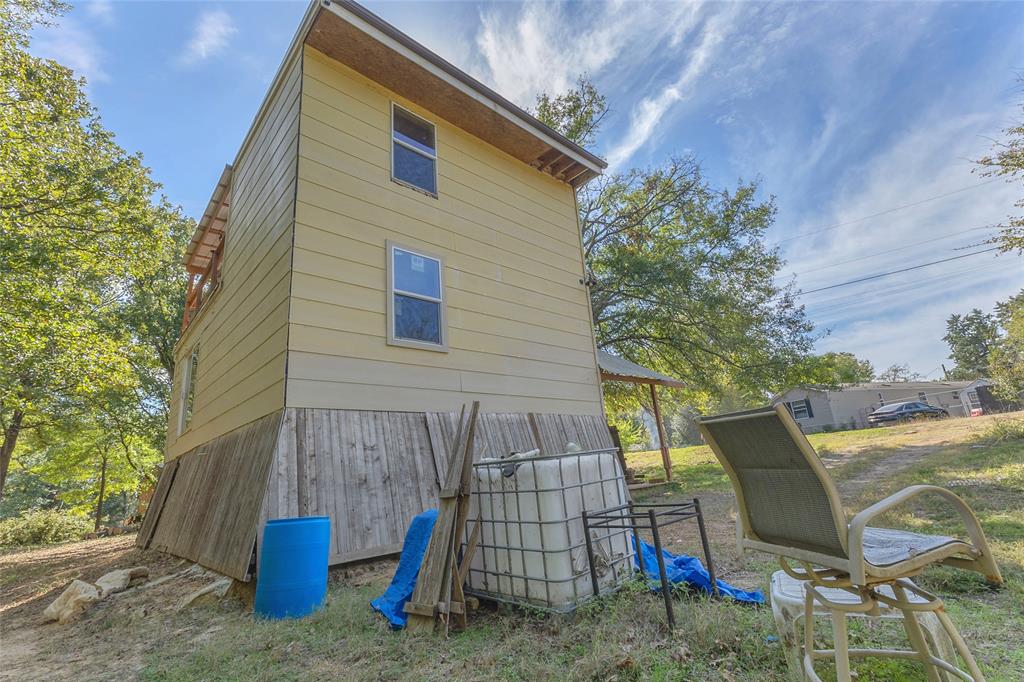 Exterior side view of the two-story home and yard