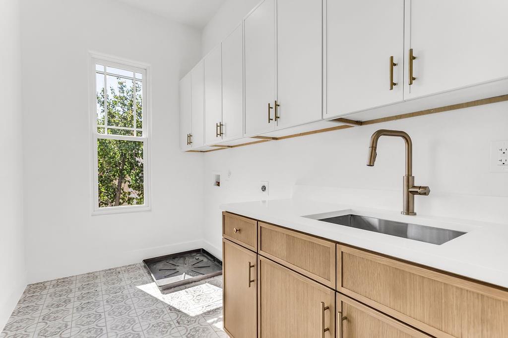 Full-size laundry room on upper level — one of TWO laundry rooms in this home for ultimate convenience