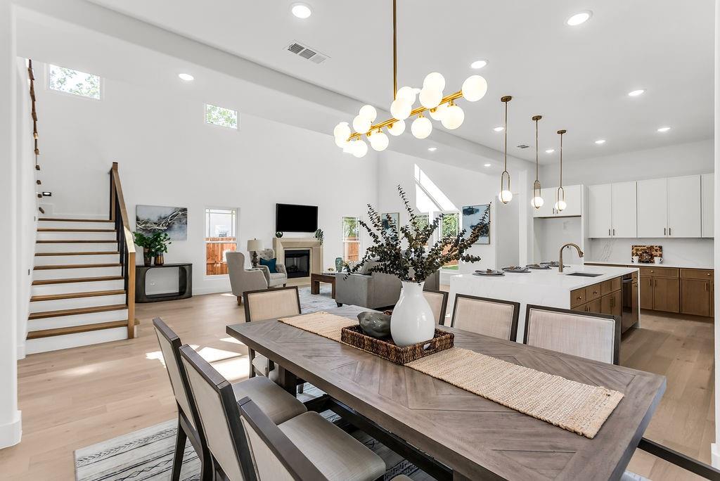 Open-concept dining seamlessly connects the kitchen, great room, and covered rear patio